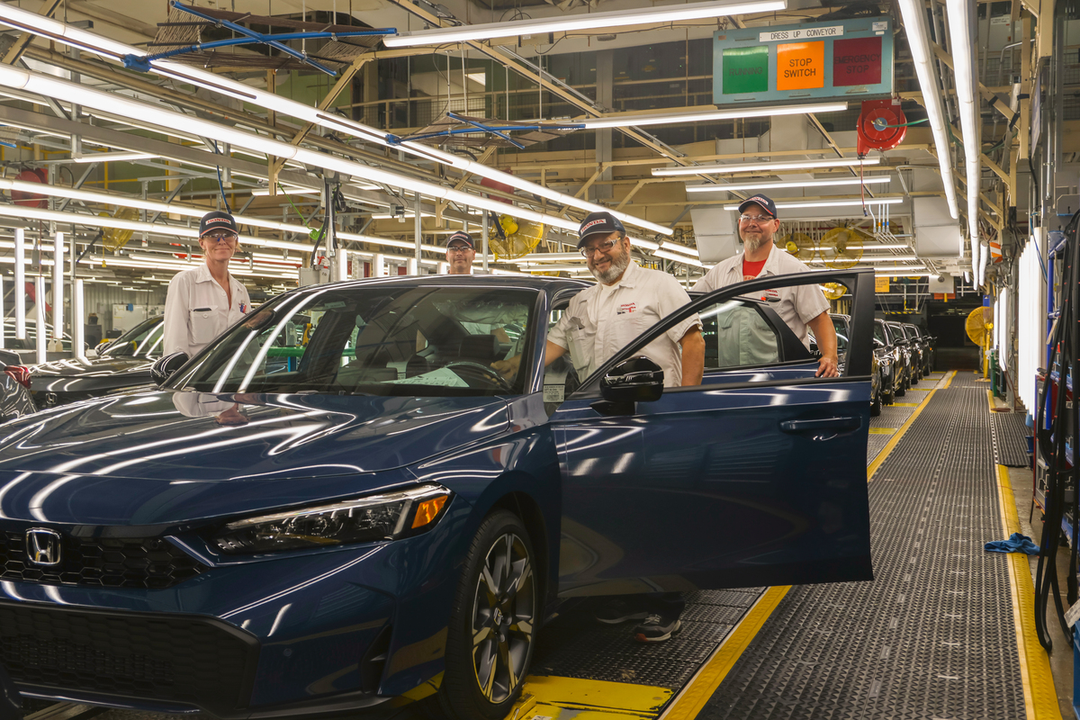 Honda of Canada Mfg. workers with Honda Civic on assembly line