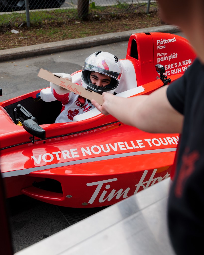 Lance Stroll and Formula 1 car in drive-thru