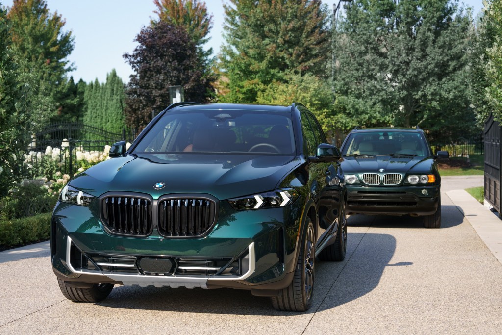 2025 BMW X5 Edition 25 Jahre model in front of first-generation BMW X5