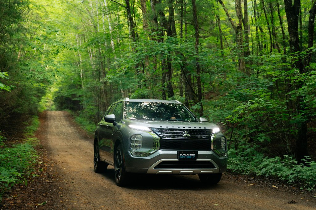Mitsubishi Outlander PHEV driving through woods