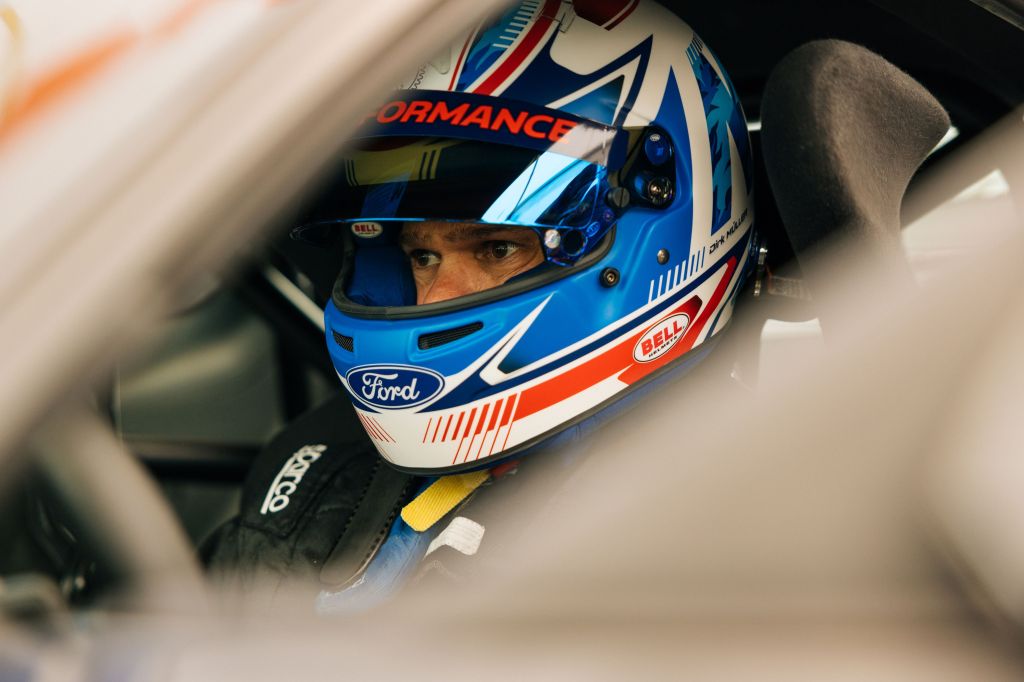 Dirk Müller in helmet inside Mustang GTD