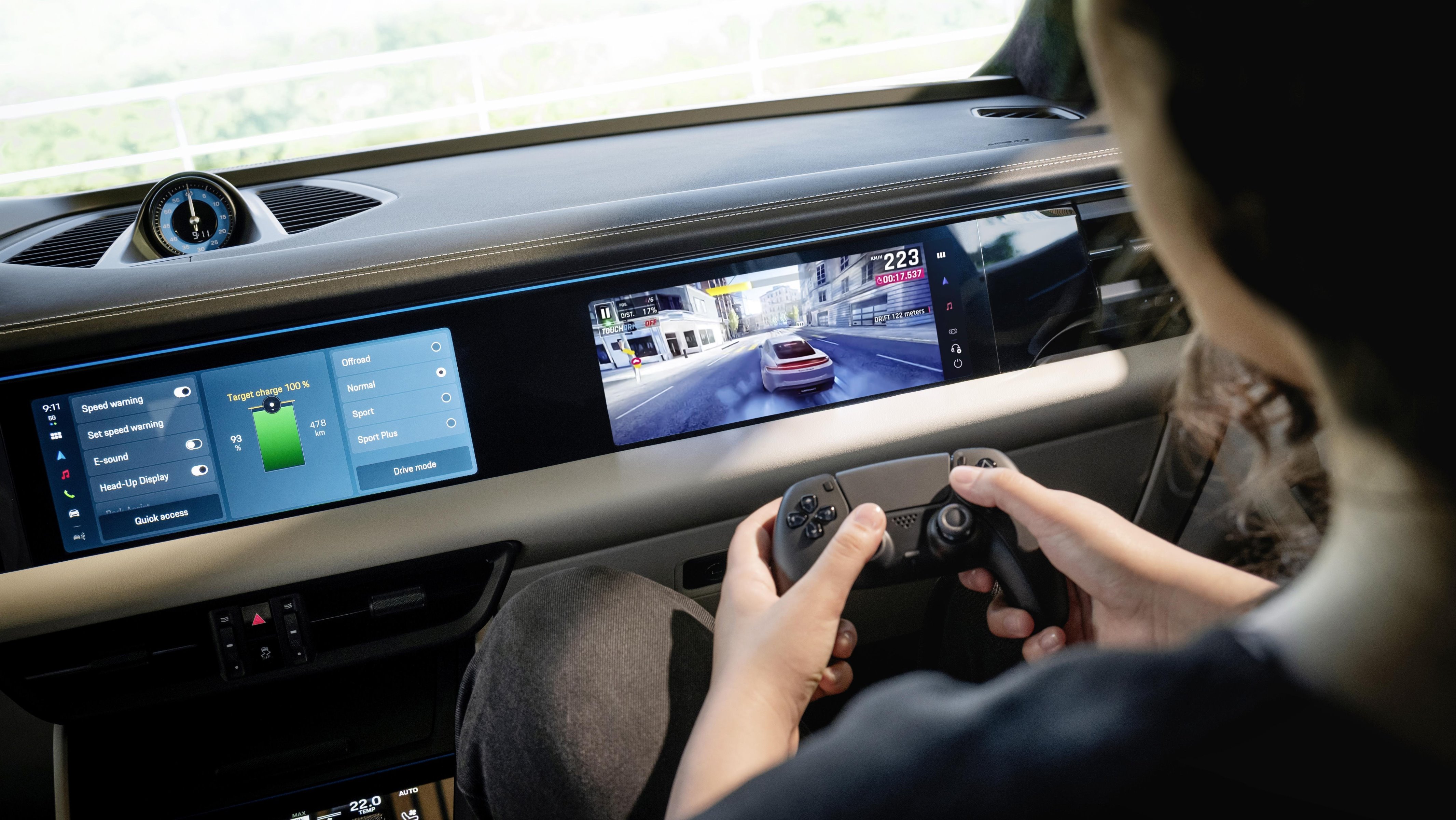 Person playing video game on Porsche Macan passenger display