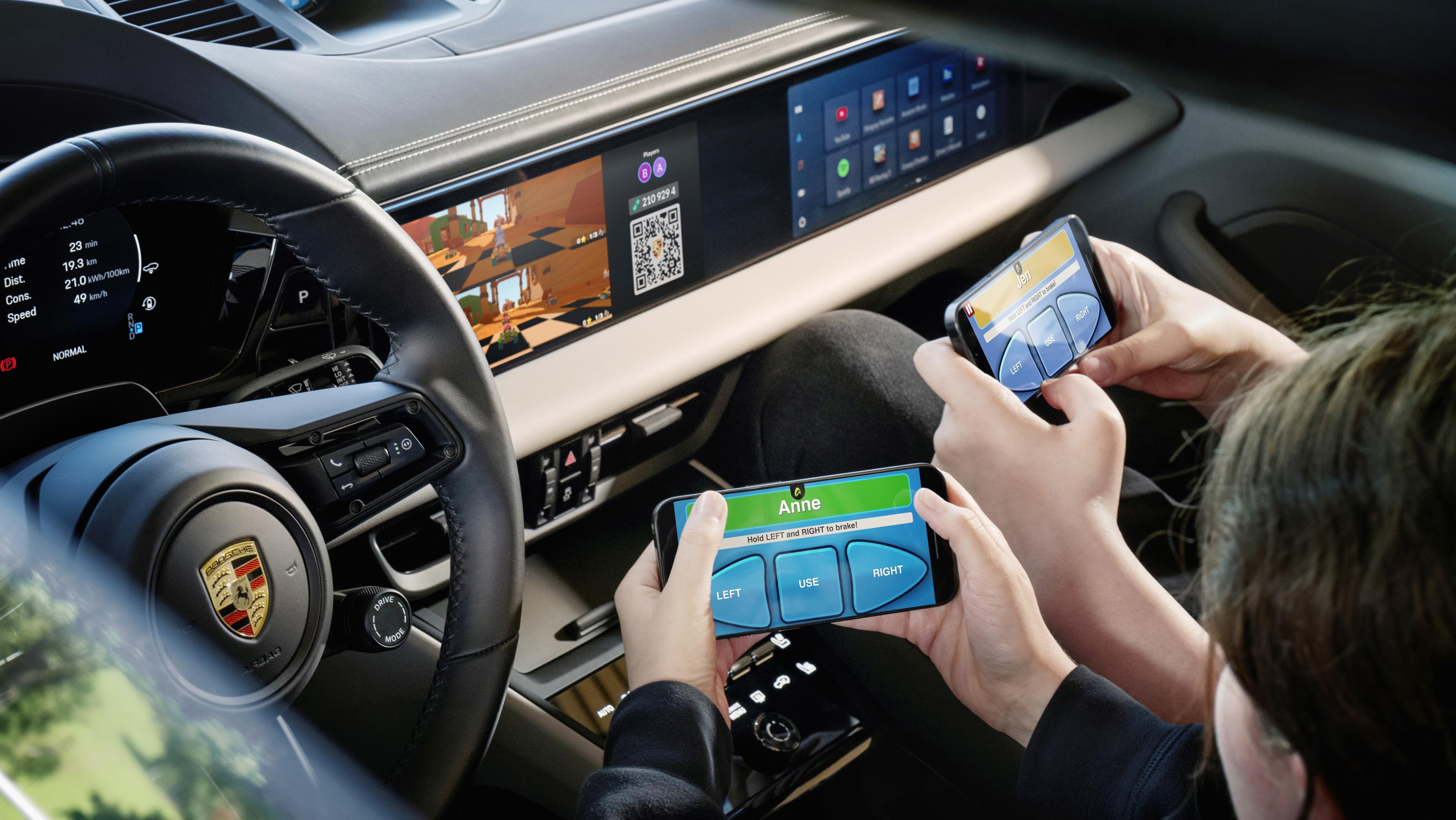Two people playing video games together on Porsche Macan centre display
