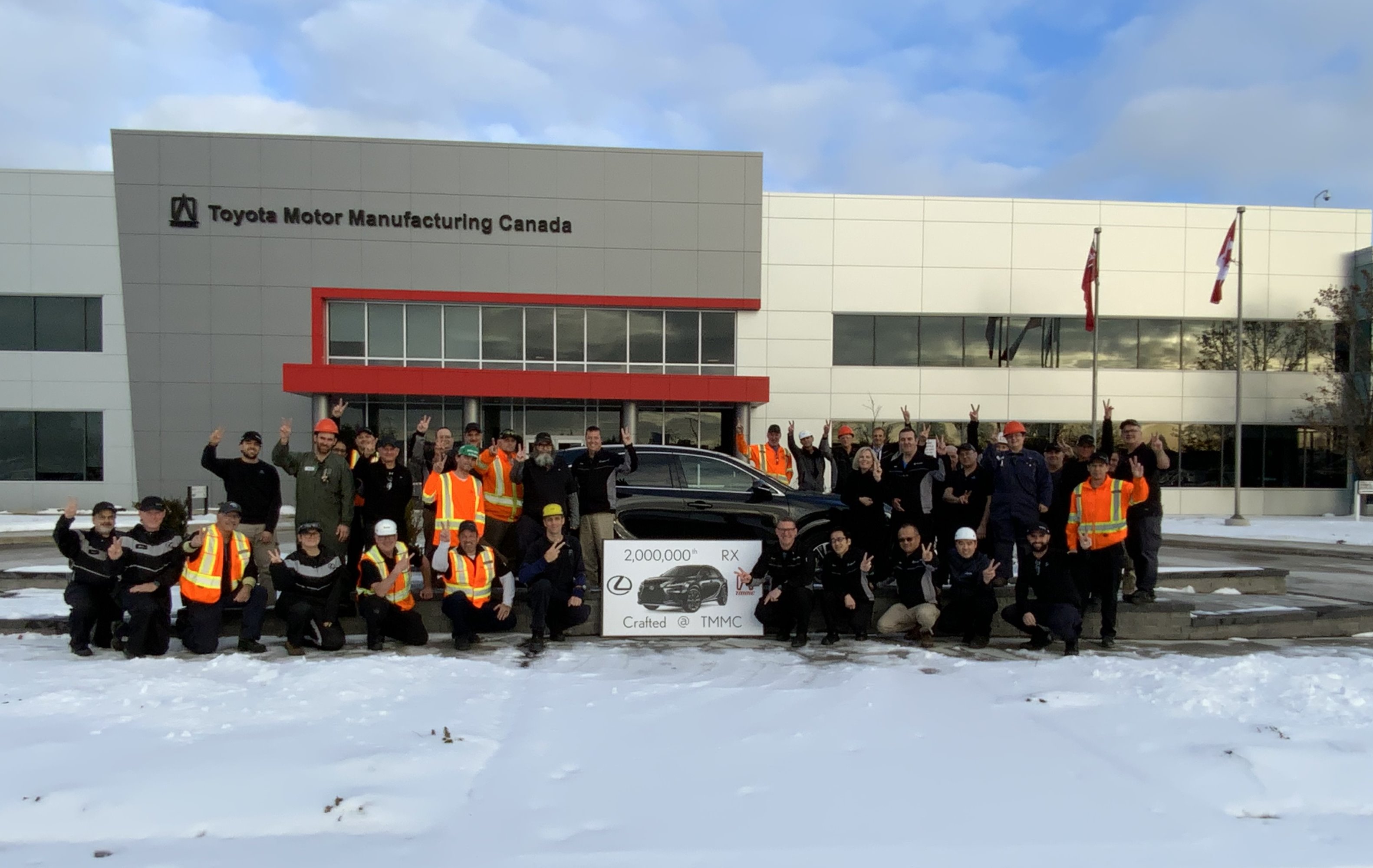 Employees around finished Lexus RX outside Toyota Motor Manufacturing Canada facility