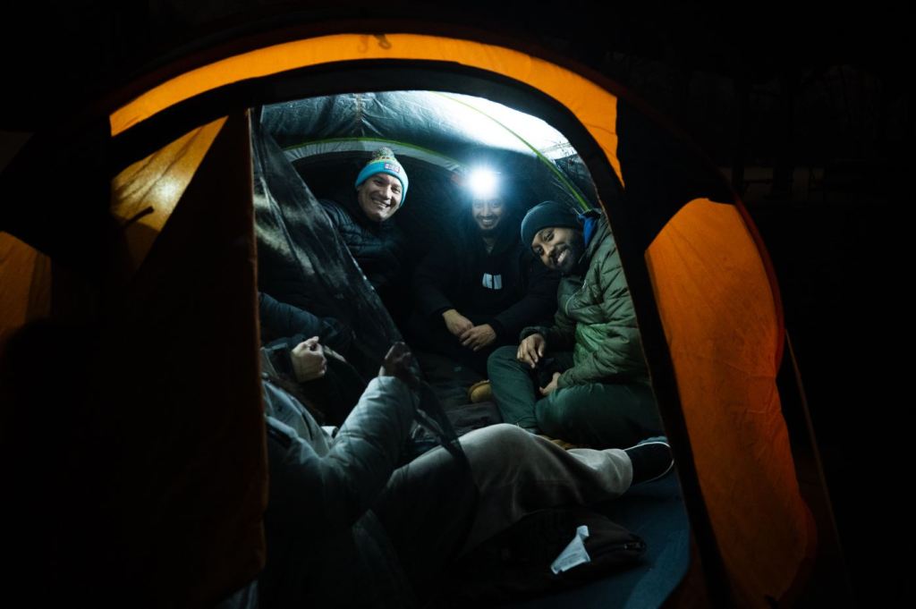 People inside tent on cold winter night