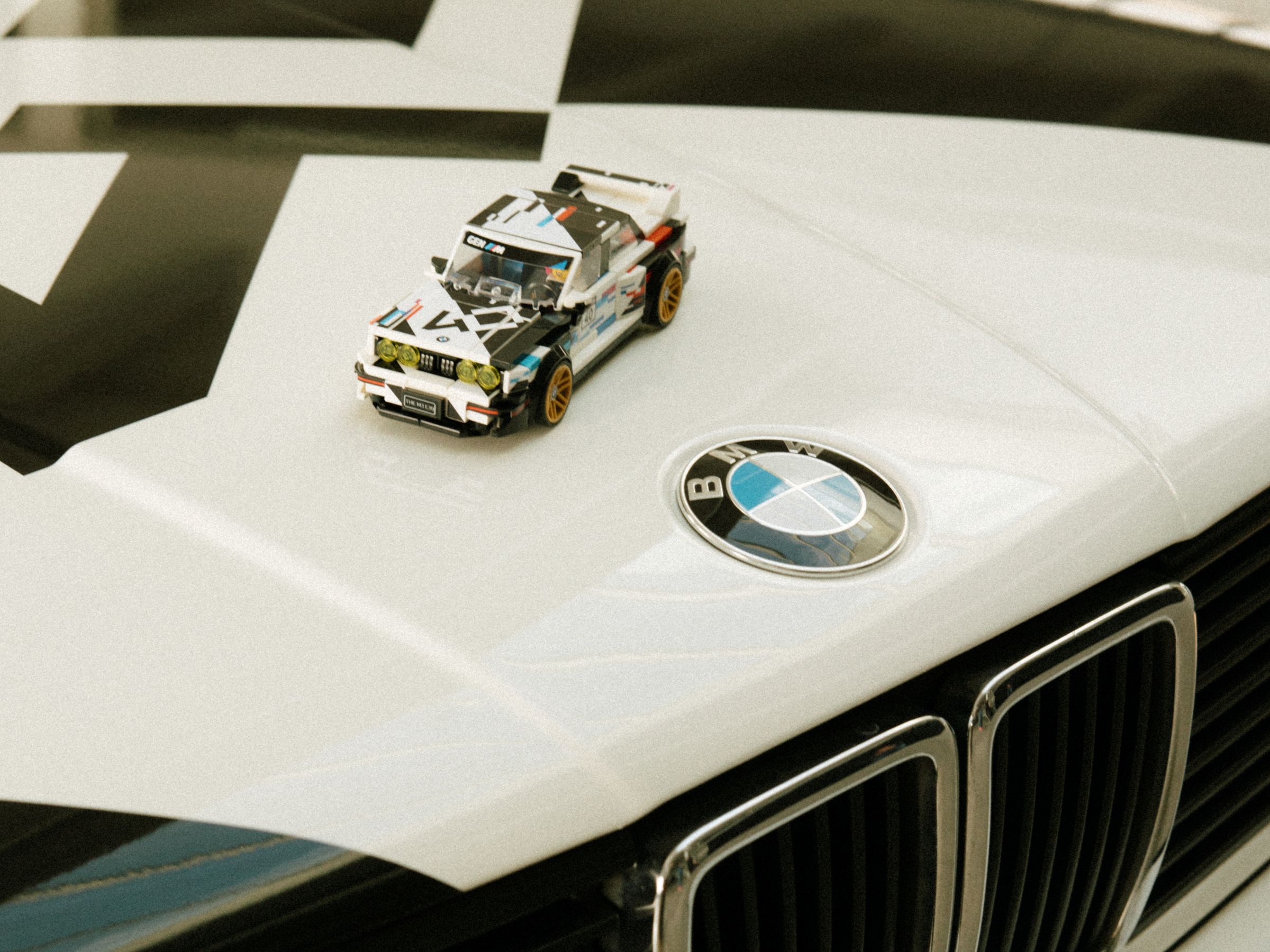 Lego Speed Champions BMW M3 on hood of BMW M3