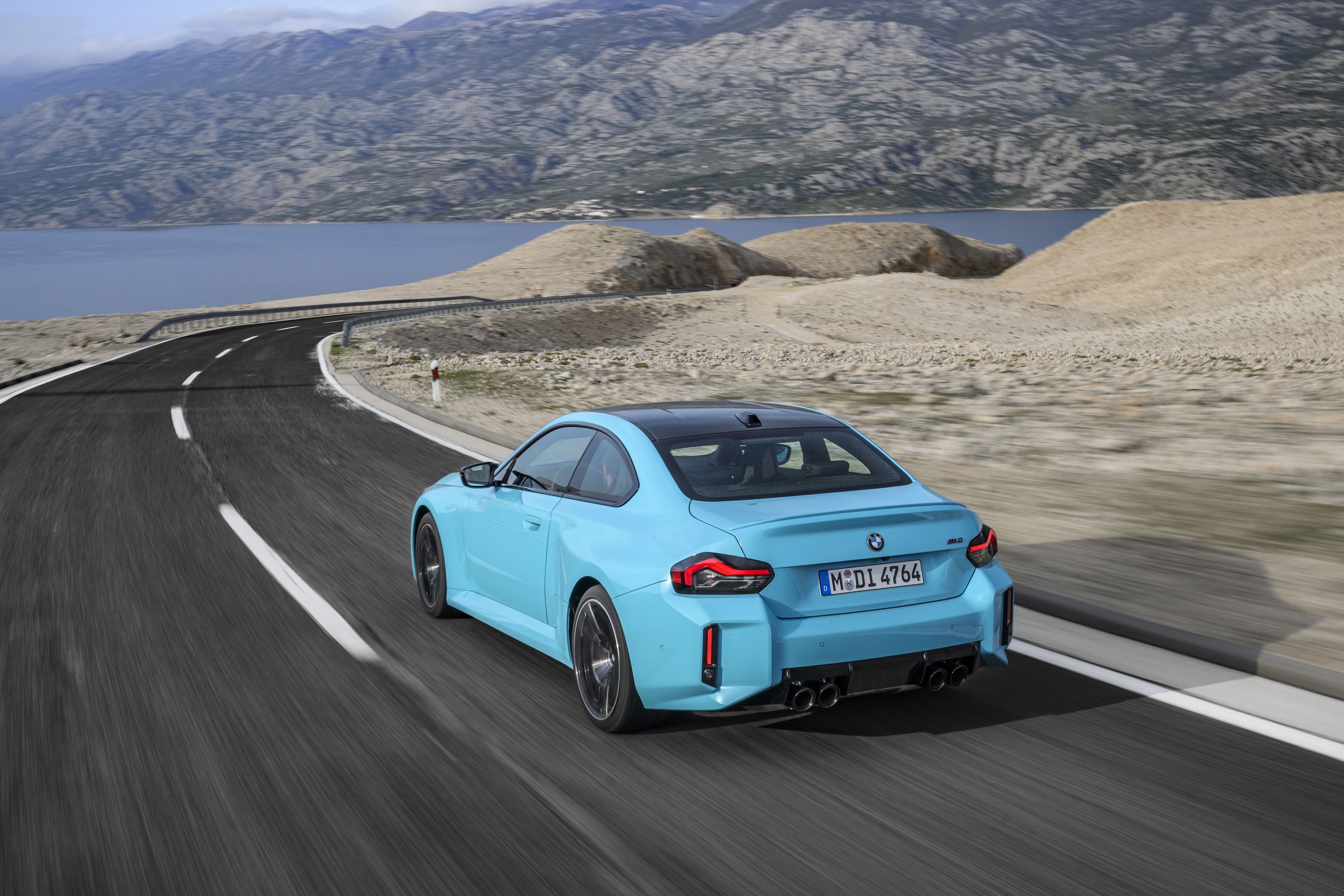 2027 BMW M2 with M xDrive driving rear of car