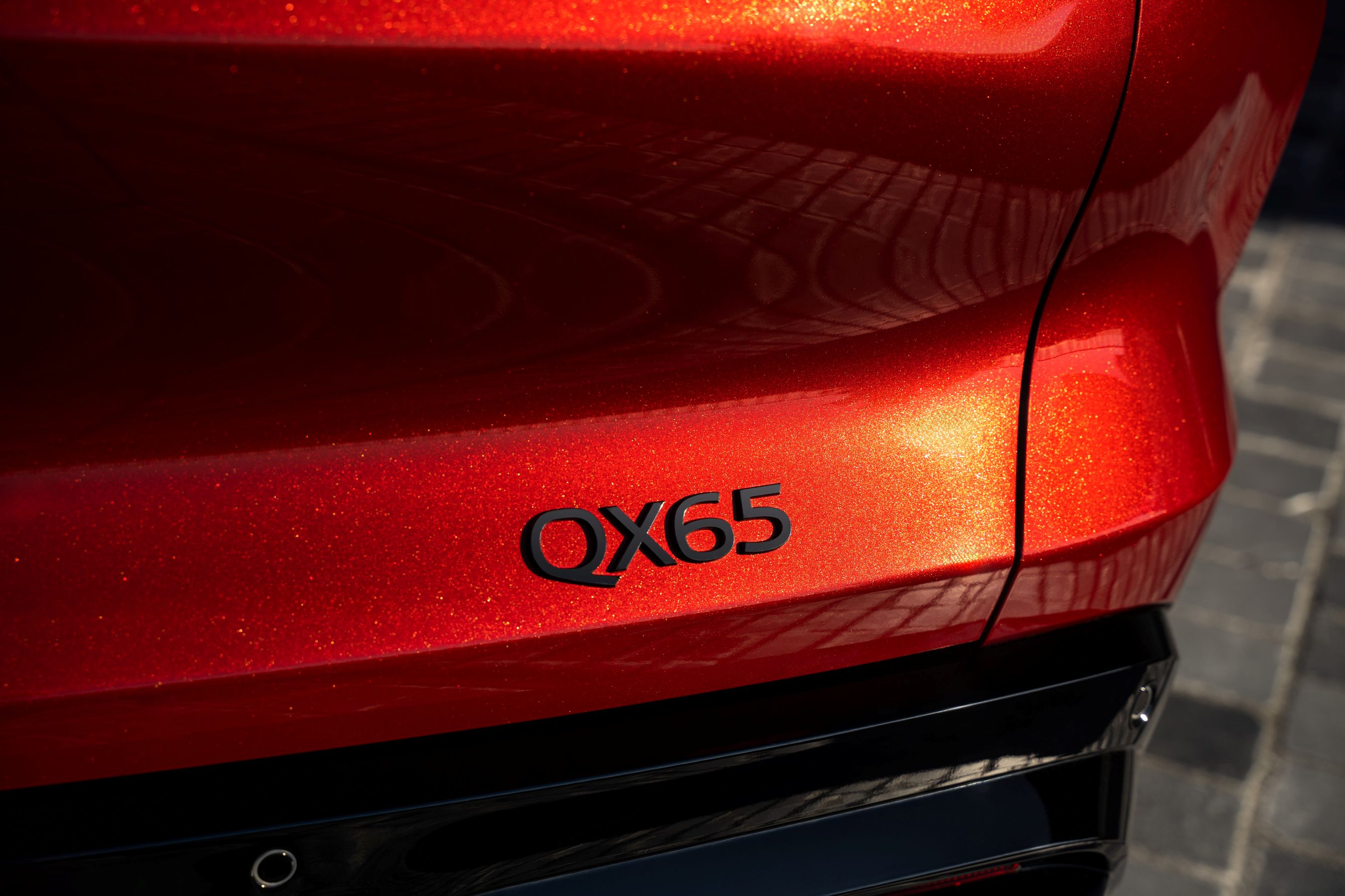 Closeup of Sunfire Red colour on 2027 Infiniti QX65