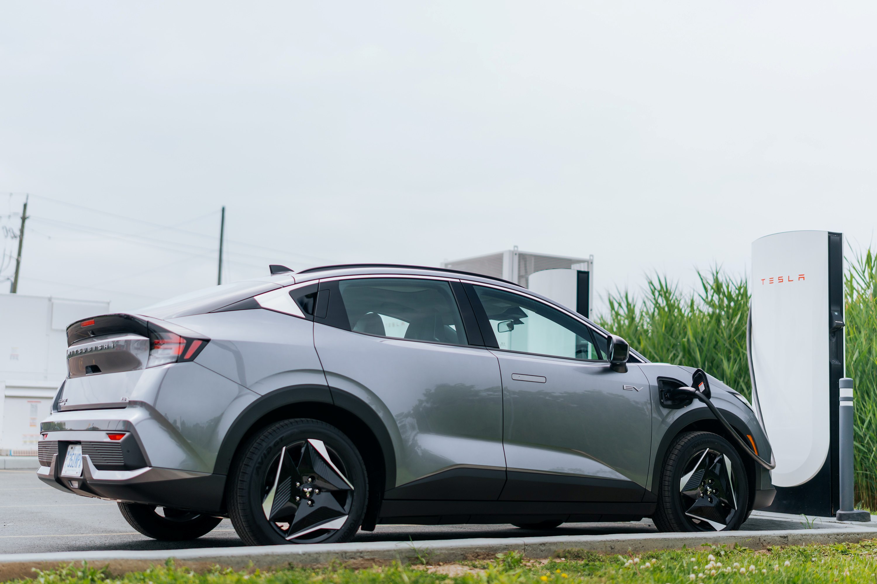 Mitsubishi Eclipse Sportback charging at Tesla Supercharger