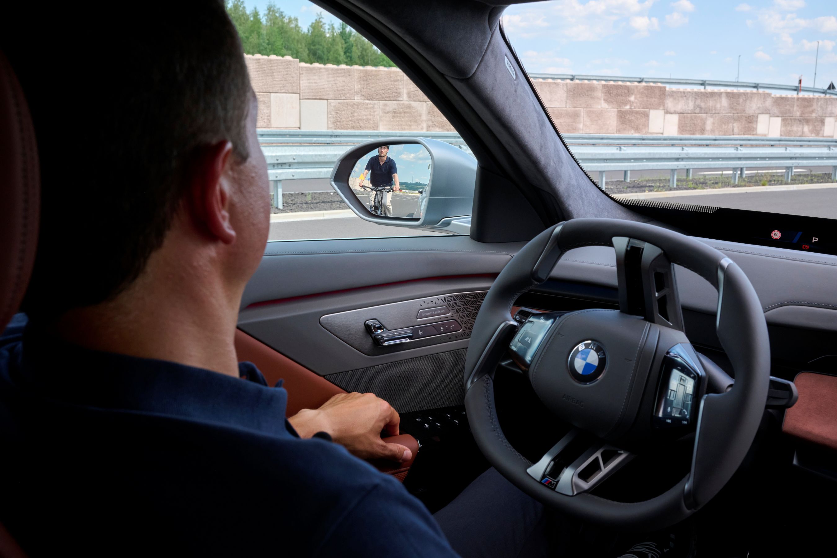 BMW driver waiting for cyclist to pass