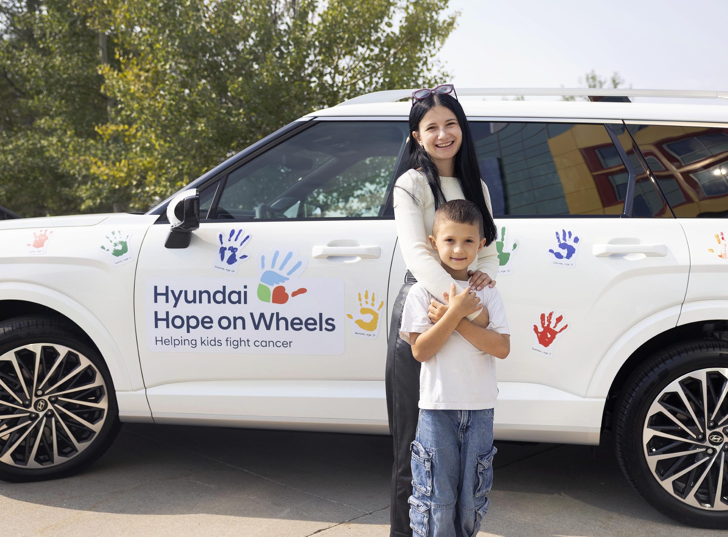Girl and boy in front of Hyundai Hope on Wheels vehicle