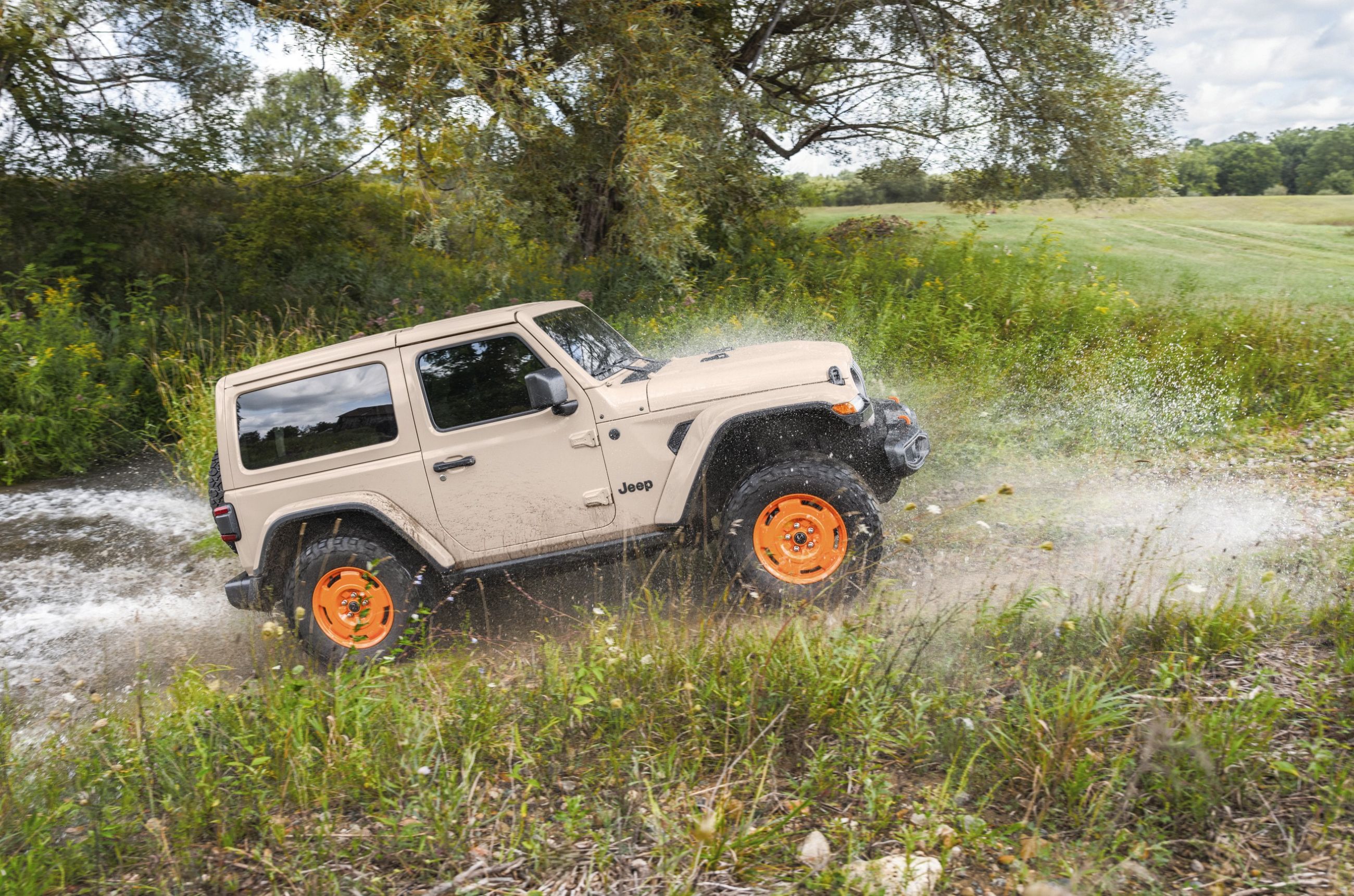 2027 Jeep Wrangler JL-2A two-door driving up hill