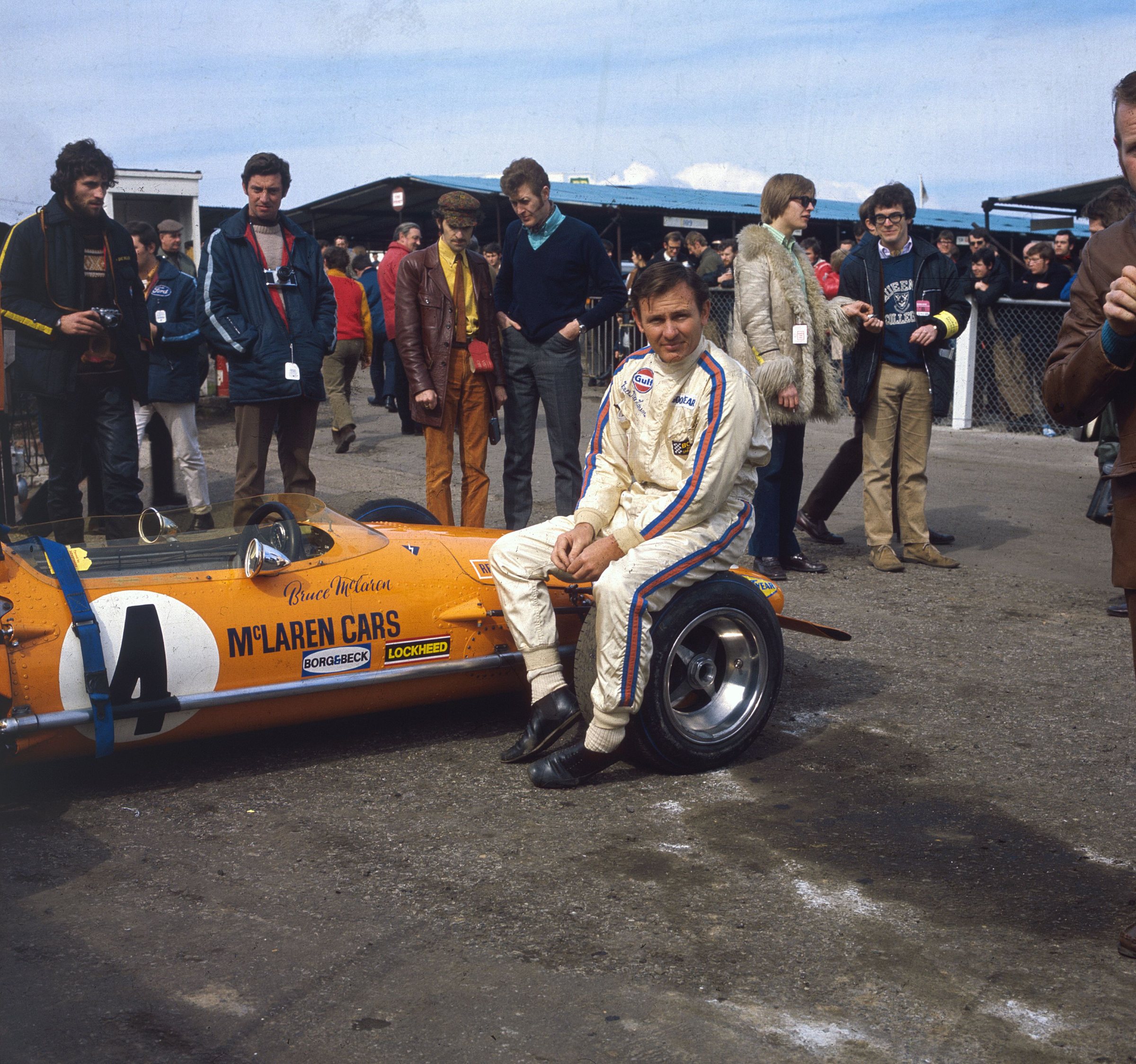 Bruce McLaren sits on the McLaren M14A before start of race in March 1970
