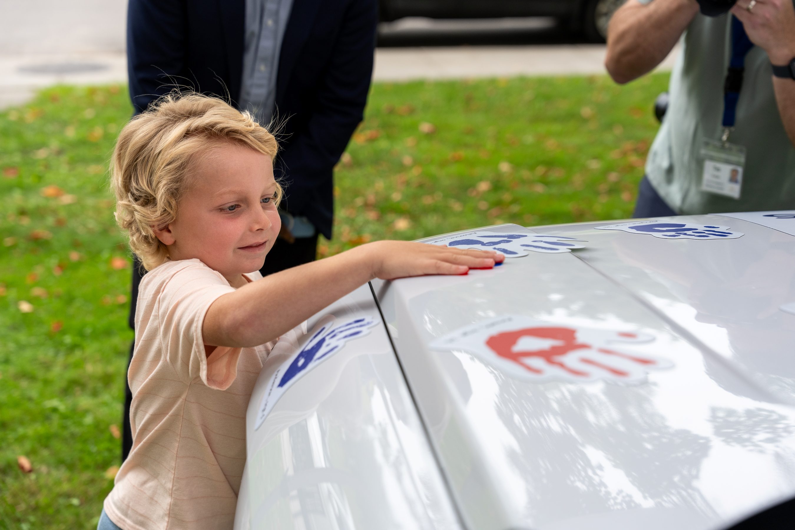 Boy places handprint onto Hyundai Hope on Wheels vehicle