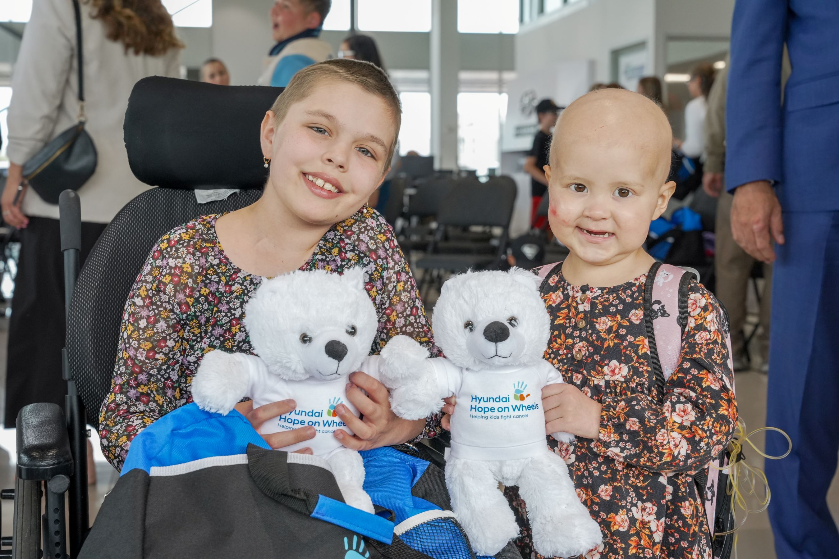Two girls holding teddy bears
