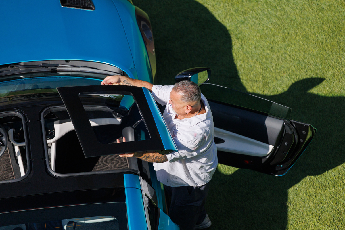 Person placing T-top roof panel onto Nissan Z Kaze