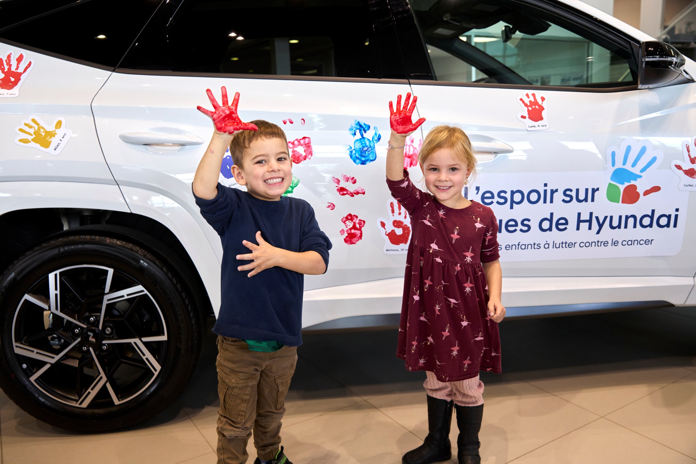 Two kids with Hyundai vehicle